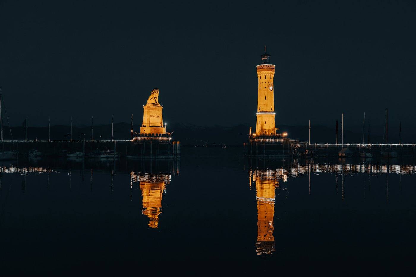 Lindau harbour at night: lighthouse and Bavarian lion